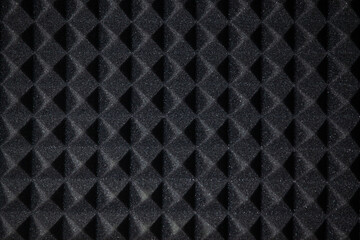 Background of sound absorbing sponge. Wall soundproofing. Pyramid style padding layer panel for voice recording. Close-up.