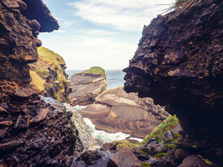 Stream on the edge of Kilkee cliff and rough stone coastline down below in a distance. Stunning...