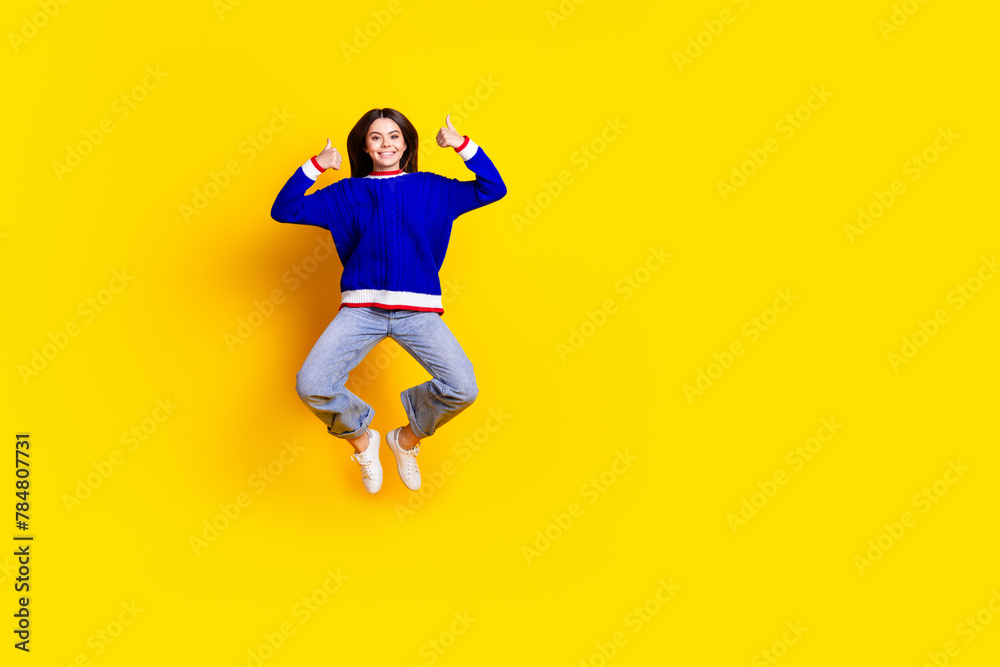 Canvas Prints full length photo of pretty teen girl jumping thumb up wear trendy knitwear blue outfit isolated on 