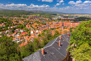 Aerial view of Wernigerode with distinctive red roofs and lush Harz foothills, Germany