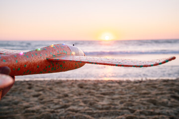Foam toy airplane ready for flight at sunset.