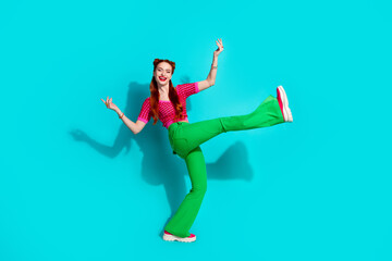 Full length photo of positive pretty lady dressed pink knitted shirt dancing emtpy space isolated blue color background