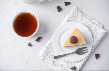 Three chocolate cake in a plate with cup of tea - 784811951