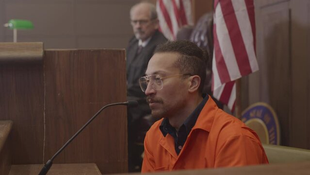 Inmate testimony close up zoom out in court room