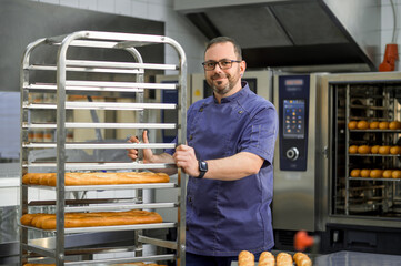 Man baker baking and selling tasty breads