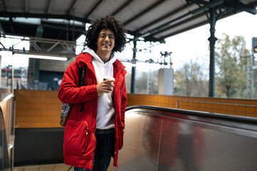 Young guy on the escalator at the railway station