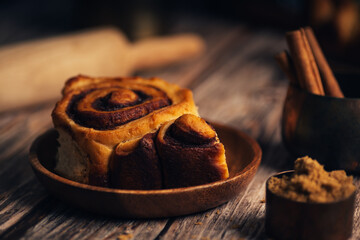 Sweet cinnamon rolls on a wooden background. Selective focus. Rustic style.