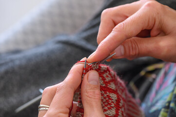 Women's hands knit socks from yarn. Knitting socks is a great activity for women.2