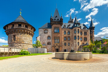 Fototapeta na wymiar Wernigerode Castle with fountain and defensive tower in Wernigerode, Germany