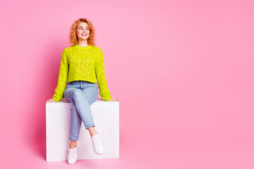 Photo of lovely cute woman dressed trendy clothes sitting cube isolated on pink color background