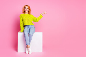 Photo of cute adorable woman dressed trendy clothes demonstrate empty space news isolated on pink color background