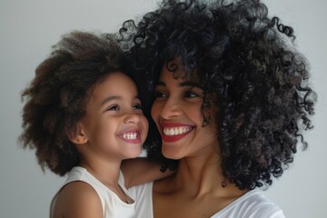 A woman is holding a child with curly hair. Happy Mother's Day concept