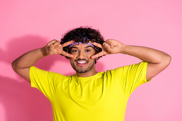 Photo of cheerful positive funny man wear stylish yellow clothes demonstrate v-sign symbol isolated...