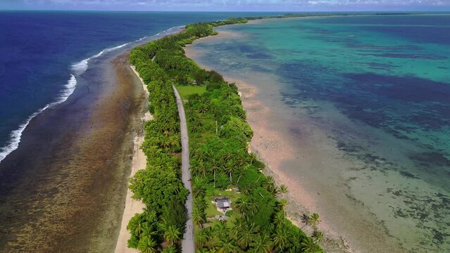 MARSHALL ISLANDS - 3.18.2024 - Excellent aerial footage moving up the west side atoll of Majuro, the Marshall Islands, with trees lining the beach.