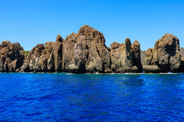 Fototapeta premium Rocky coast in the resort part of the Mediterranean or Aegean Sea. Background with selective focus and copy space