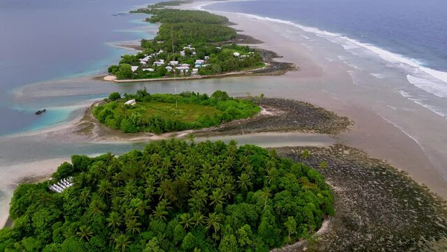 MARSHALL ISLANDS - 3.18.2024 - Very good aerial footage moving along green clusters of land on the coast of Majuro in the Marshall Islands.