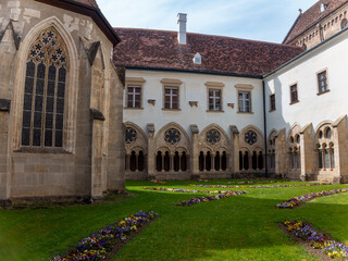 Heiligenkreuz, Austria - April 14, 2024: overall view on the details of exterior and interior of the Stift Heiligenkreuz abbey - 784838942
