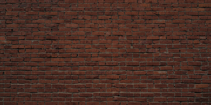 Old brown brick wall background. Wide high resolution textured banner.