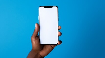 Aerial view of a blue background; the image features a person's arm holding a cellphone with a white screen