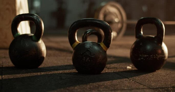 Kettlebells placed in line on floor in daylight
