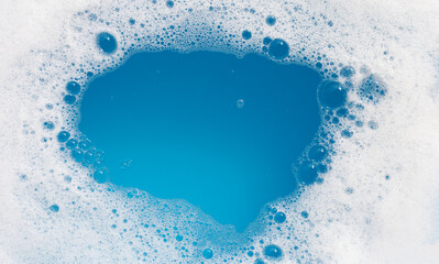 Detergent foam bubble on wate. Blue background, Soap sud