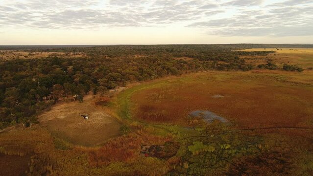 Sunset, wetland, grass, water, trees, helicopter, jet ranger, river, clouds, aerial view, Cuatir Conservation Area, Angola, Africa