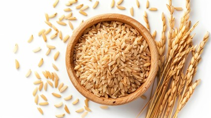 Coarse brown rice in wooden bowl with paddy rice isolated on white background, top view, flat lay.