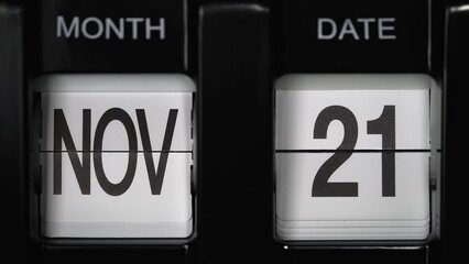 retro flip calendar with a date change from the twentieth of November to the twenty first of November. daily calendar with a change of days of the month. close up.