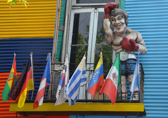 A colorful building in the La Boca neighborhood with statues and flags. Buenos Aires, Argentina