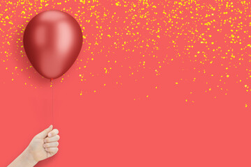 Female hand holding the red balloon on red background with confetti. Empty space for text - 784889504