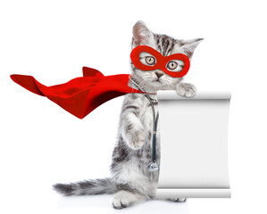 Cute kitten wearing like a doctor with superhero cape and with stethoscope on his neck standing on hind legs, looks at camera and shows empty list. Isolated on white background - 784889750