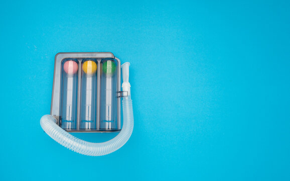 An incentive spirometer on a blue background.