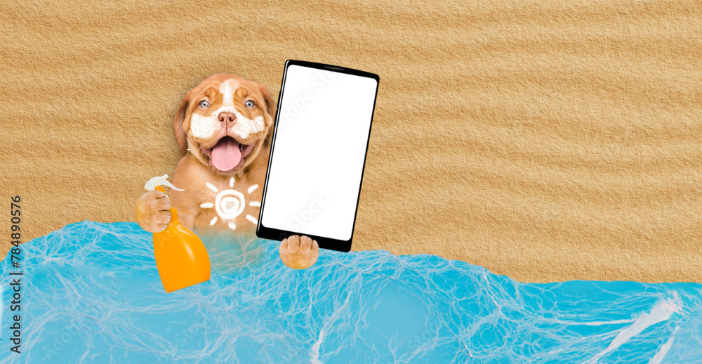Poster Funny Mastiff puppy at beach applying suntan lotion or sun block and showing big smartphone with white blank screen in it paw. Empty space for text