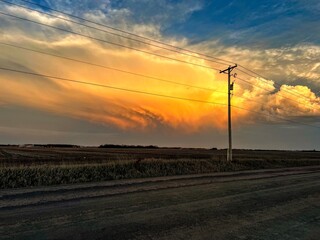 A glowing sunset against a midwestern power pole