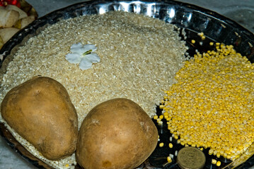 raw rice potato pulses arranged in a steel plate as an offering for Hindu puja in India