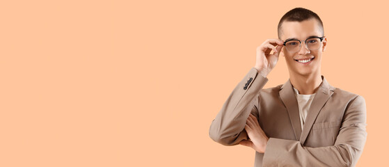 Handsome young businessman on orange background