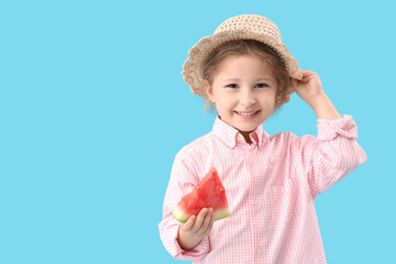 Little girl in wicker hat with slice of fresh watermelon on blue background
