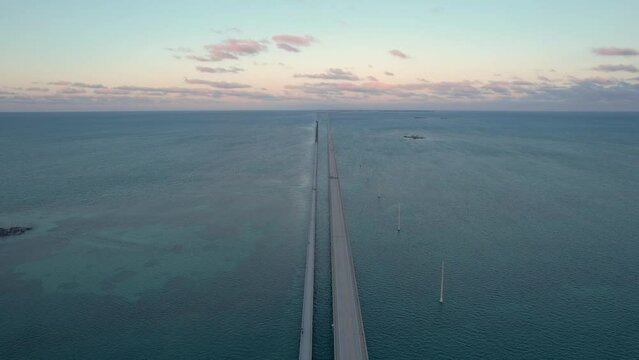 Seven Mile Bridge Sunset in Florida Keys Aerial View. Fly Over American Bridge Over Blue Ocean Pastel Colored Sky
