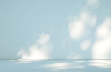 Abstract light blue wall background in empty room with light and shadow.