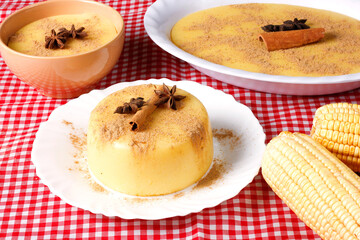 Curau, cream of corn sweet and dessert typical of the Brazilian cuisine, placed in ceramic bowl on wooden table.