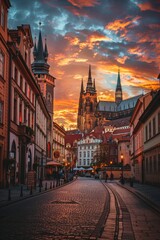 Panoramic view of a historic European city, cobblestone streets, quaint buildings, and a towering cathedral against a sunset sky - obrazy, fototapety, plakaty