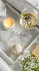 Top-view shot of a luxurious bath tray with a wine glass, a bar of artisanal soap, a single bath bomb, and a scented candle