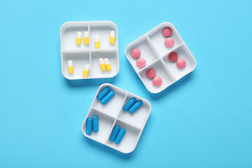 Containers with different pills on blue background
