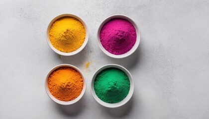 Ready for Holi: Bowls of Vibrant Colored Powder on a White Background