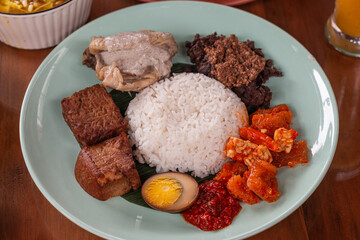 Traditional Indonesian food is called 'gudeg' a spiced mixture made from young jackfruit cooked with coconut milk plus rice and chili sauce