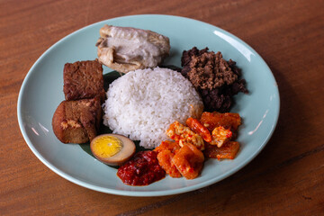 Traditional Indonesian food is called 'gudeg' a spiced mixture made from young jackfruit cooked with coconut milk plus rice and chili sauce