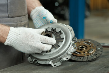 Car service.Car repair and maintenance.A new clutch kit is in the hands of an auto mechanic....