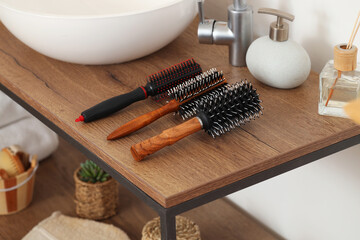 Round hair brushes on table in bathroom, closeup