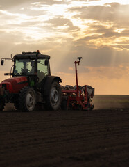 Farmer with tractor seeding - 784919907