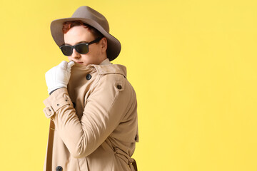 Fototapeta premium Male spy in disguise on yellow background